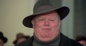 Movie still from “Salò, or the 120 Days of Sodom” (1975), directed by Pier Paolo Pasolini – A person wearing a hat; Close Up shot, Low angle