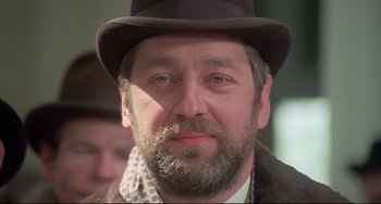 Movie still from “Salò, or the 120 Days of Sodom” (1975), directed by Pier Paolo Pasolini – A person wearing a hat; Close Up shot, Low angle