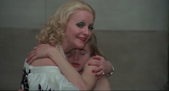 Movie still from “Salò, or the 120 Days of Sodom” (1975), directed by Pier Paolo Pasolini – A woman hugging a young girl in a white dress; Close Up shot, Low angle