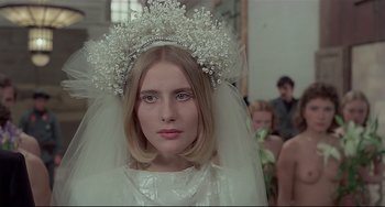 Movie still from “Salò, or the 120 Days of Sodom” (1975), directed by Pier Paolo Pasolini – A young woman wearing a veil and a tiara; Close Up shot, Over the shoulder angle