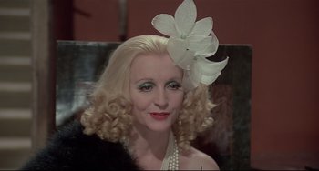 Movie still from “Salò, or the 120 Days of Sodom” (1975), directed by Pier Paolo Pasolini – A woman with a flower in her hair; Close Up shot, Over the shoulder angle