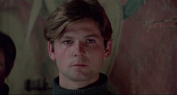 Movie still from “Salò, or the 120 Days of Sodom” (1975), directed by Pier Paolo Pasolini – A person wearing a sweater; Close Up shot, Low angle