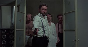 Movie still from “Salò, or the 120 Days of Sodom” (1975), directed by Pier Paolo Pasolini – A group of men standing in a room; Medium shot, Low angle