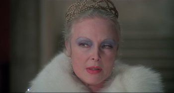 Movie still from “Salò, or the 120 Days of Sodom” (1975), directed by Pier Paolo Pasolini – A person wearing a tiara; Close Up shot, Over the shoulder angle