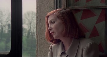 Movie still from “Salò, or the 120 Days of Sodom” (1975), directed by Pier Paolo Pasolini – A woman with red hair looking out of a window; Close Up shot, Low angle