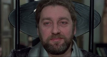 Movie still from “Salò, or the 120 Days of Sodom” (1975), directed by Pier Paolo Pasolini – A person with a beard; Close Up shot, Low angle