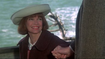 Movie still from “Same Time, Next Year” (1978), directed by Robert Mulligan – An older woman wearing a white hat holding a man's hand; Close Up shot, Over the shoulder angle