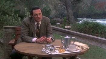 Movie still from “Same Time, Next Year” (1978), directed by Robert Mulligan – A man sitting at a table with a tray of food on top of it; Medium shot, High angle