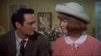 Movie still from “Same Time, Next Year” (1978), directed by Robert Mulligan – A man and a woman sitting next to each other in a room; Close Up shot, Over the shoulder angle