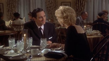 Movie still from “Same Time, Next Year” (1978), directed by Robert Mulligan – A man and a woman sitting at a dinner table; Medium shot, Over the shoulder angle