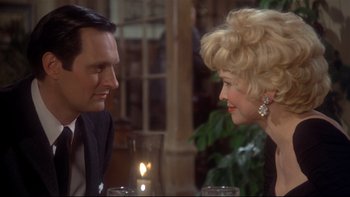 Movie still from “Same Time, Next Year” (1978), directed by Robert Mulligan – A man and a woman sitting at a dinner table; Close Up shot, Over the shoulder angle