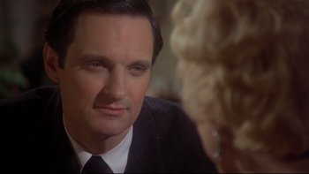 Movie still from “Same Time, Next Year” (1978), directed by Robert Mulligan – A person wearing a suit and tie; Close Up shot, Over the shoulder angle