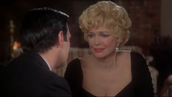 Movie still from “Same Time, Next Year” (1978), directed by Robert Mulligan – An older woman in a black dress talking to a younger man; Close Up shot, Over the shoulder angle