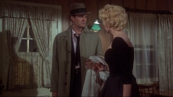 Movie still from “Same Time, Next Year” (1978), directed by Robert Mulligan – A man and a woman are standing in front of each other; Medium shot, Over the shoulder angle