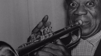Movie still from “Same Time, Next Year” (1978), directed by Robert Mulligan – A black and white photo of a man holding a trumpet; Extreme Close Up shot, Low angle