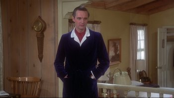 Movie still from “Same Time, Next Year” (1978), directed by Robert Mulligan – A man standing in front of a mirror in a dressing gown; Medium shot, Low angle