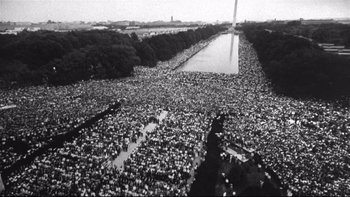 Movie still from “Same Time, Next Year” (1978), directed by Robert Mulligan – An aerial view of a crowd of people gathered in the middle of a river; Extreme Wide shot, Overhead angle