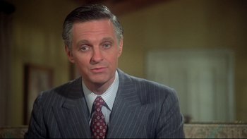 Movie still from “Same Time, Next Year” (1978), directed by Robert Mulligan – A person wearing a suit and tie; Close Up shot, High angle