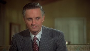 Movie still from “Same Time, Next Year” (1978), directed by Robert Mulligan – A person wearing a suit and tie; Close Up shot, Over the shoulder angle