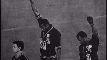 Movie still from “Same Time, Next Year” (1978), directed by Robert Mulligan – An athlete raises his arm in the air; Medium shot, Low angle