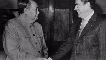 Movie still from “Same Time, Next Year” (1978), directed by Robert Mulligan – Two men shaking hands in a room; Medium shot, Over the shoulder angle