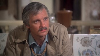 Movie still from “Same Time, Next Year” (1978), directed by Robert Mulligan – An older man with a beard and mustache wearing a tan jacket; Close Up shot, High angle