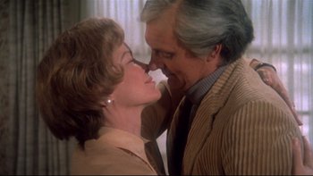 Movie still from “Same Time, Next Year” (1978), directed by Robert Mulligan – An older man and a younger woman kissing each other; Close Up shot, Low angle