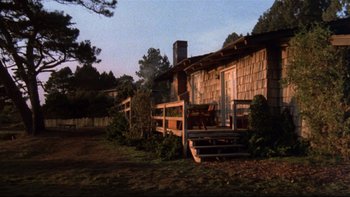 Movie still from “Same Time, Next Year” (1978), directed by Robert Mulligan – A wooden house with a porch and a fire place; Wide shot, Low angle