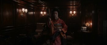 Movie still from “1899” (2022), created by Jantje Friese – A woman in a red and orange kimono holding a wooden sword; Medium shot, Low angle