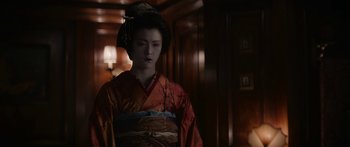 Movie still from “1899” (2022), created by Jantje Friese – A geisha in a red and orange kimono; Close Up shot, Over the shoulder angle