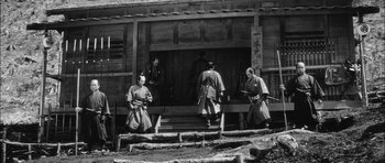 Movie still from “Samurai Rebellion” (1967), directed by Masaki Kobayashi – A group of people standing on steps in front of a building; Wide shot, Low angle