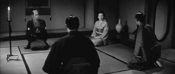 Movie still from “Samurai Rebellion” (1967), directed by Masaki Kobayashi – A man and a woman sitting in a room; Wide shot, Over the shoulder angle