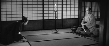 Movie still from “Samurai Rebellion” (1967), directed by Masaki Kobayashi – An empty room with a candle and a bowl; Wide shot, High angle