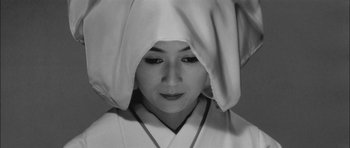 Movie still from “Samurai Rebellion” (1967), directed by Masaki Kobayashi – A woman in a white robe with a hood on her head; Close Up shot, High angle