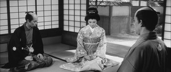 Movie still from “Samurai Rebellion” (1967), directed by Masaki Kobayashi – A woman in a kimono sitting on the ground; Wide shot, High angle