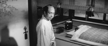 Movie still from “Samurai Rebellion” (1967), directed by Masaki Kobayashi – A man standing in front of a room; Medium shot, Low angle
