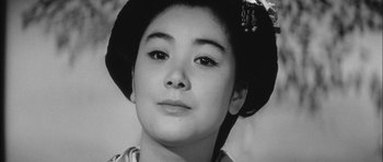 Movie still from “Samurai Rebellion” (1967), directed by Masaki Kobayashi – A young woman wearing a hat and looking at the camera; Close Up shot, Low angle
