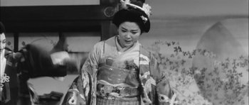 Movie still from “Samurai Rebellion” (1967), directed by Masaki Kobayashi – A woman in a kimono is standing in front of a wall; Medium shot, Low angle