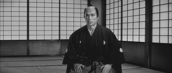 Movie still from “Samurai Rebellion” (1967), directed by Masaki Kobayashi – A black and white photo of a man in a kimono; Close Up shot, Low angle