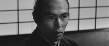 Movie still from “Samurai Rebellion” (1967), directed by Masaki Kobayashi – A black and white photo of a man with a goatee; Close Up shot, Low angle