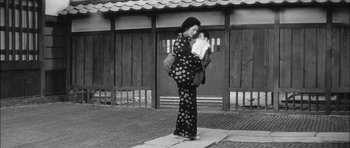 Movie still from “Samurai Rebellion” (1967), directed by Masaki Kobayashi – A woman carrying a baby in a kimono; Medium shot, Low angle