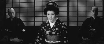 Movie still from “Samurai Rebellion” (1967), directed by Masaki Kobayashi – A young woman in a kimono is wearing a headpiece; Medium shot, Low angle
