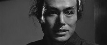Movie still from “Samurai Rebellion” (1967), directed by Masaki Kobayashi – A black and white photo of a man's face; Extreme Close Up shot, Low angle