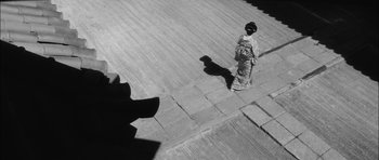 Movie still from “Samurai Rebellion” (1967), directed by Masaki Kobayashi – A person walking down the street in a kimono; Extreme Wide shot, High angle