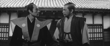 Movie still from “Samurai Rebellion” (1967), directed by Masaki Kobayashi – Two men in traditional garb talking to each other; Medium shot, Low angle