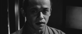 Movie still from “Samurai Rebellion” (1967), directed by Masaki Kobayashi – A black and white photo of a man in a robe; Close Up shot, Low angle