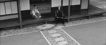 Movie still from “Samurai Rebellion” (1967), directed by Masaki Kobayashi – Two men sitting on steps in traditional japanese garb; Wide shot, High angle