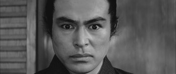 Movie still from “Samurai Rebellion” (1967), directed by Masaki Kobayashi – A person's face in a black and white photo; Close Up shot, Low angle