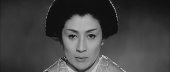 Movie still from “Samurai Rebellion” (1967), directed by Masaki Kobayashi – A black - and - white photo of a woman in a geisha outfit; Close Up shot, Low angle