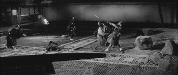 Movie still from “Samurai Rebellion” (1967), directed by Masaki Kobayashi – A black and white photo of a group of people playing a game; Extreme Wide shot, High angle